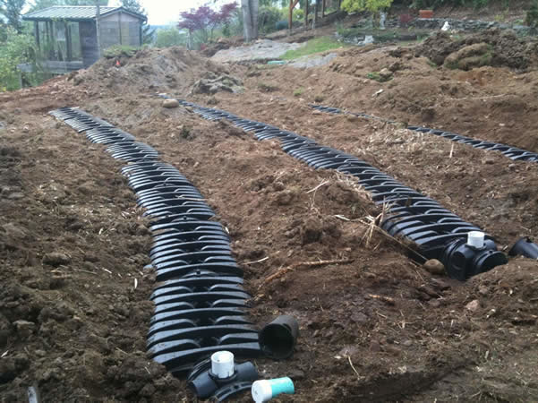 Multiple graveless chamber laterals installed as part of a complete pressurized drainfield system. 