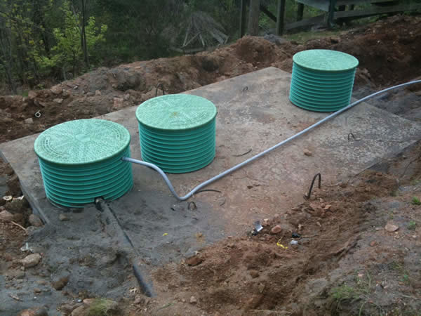 A 3 compartment tank being installed for a pressure distribution system.